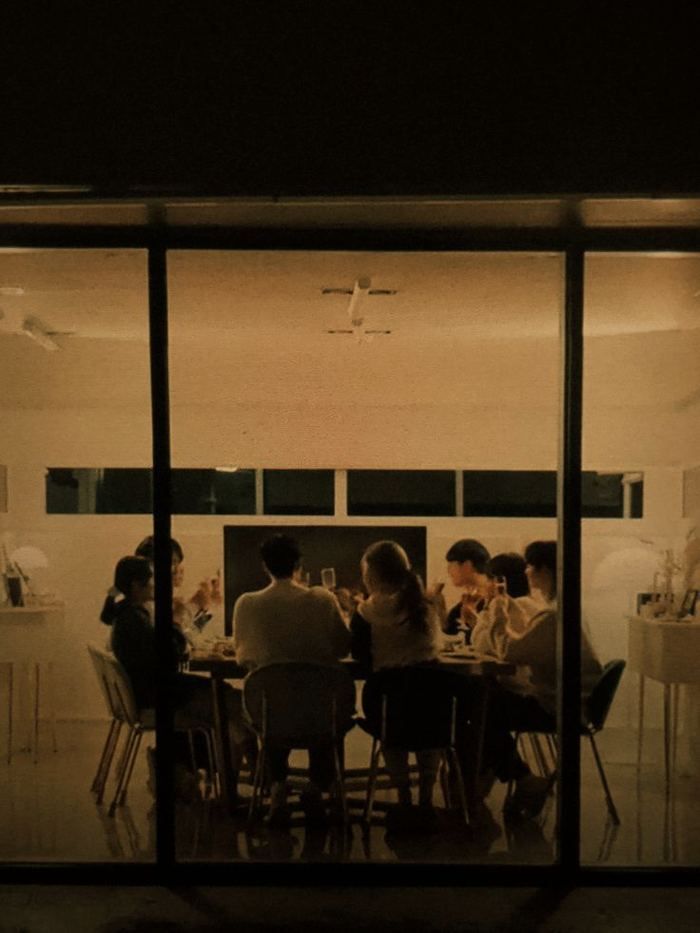 Team gathered around a table in a glass-walled room